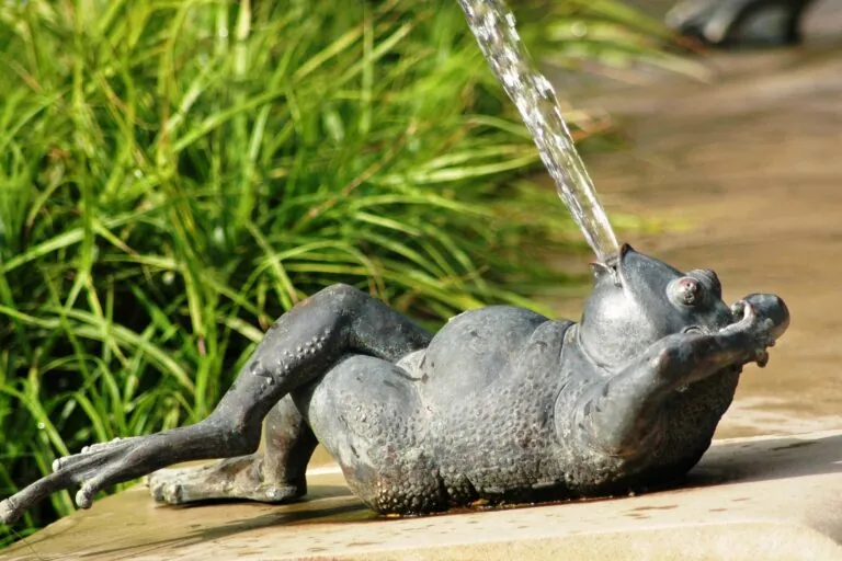 Frog sculpture spitting water out of its mouth