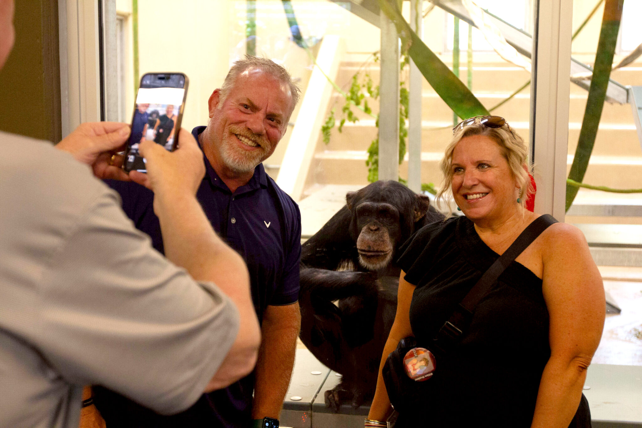 People taking a picture with a chimpanzee